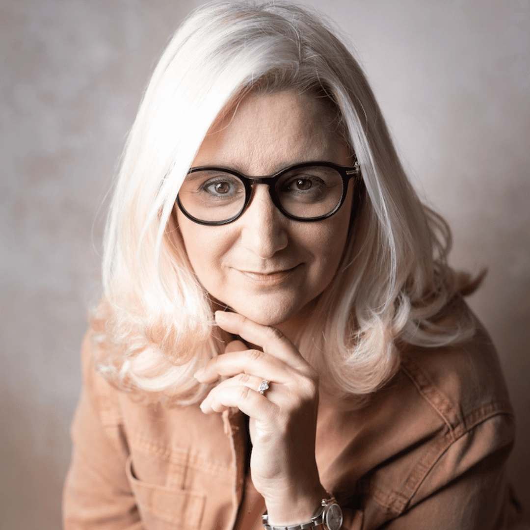 Headshot of Nathalie, career coach for executives and professionals, smiling with hand resting on chin.